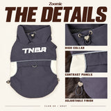 Gray dog vest with close-up views of its high collar, contrast panels and adjustable hem finish.