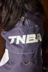 Original close-up photograph of the vest collar adjustment cord, printed back panel and metal attachment ring.